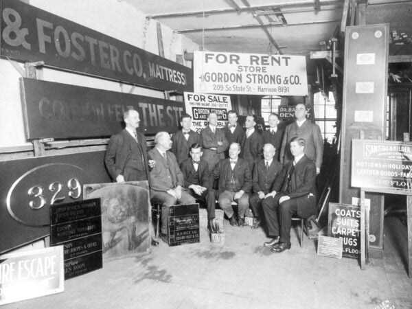 Old photo of people in a signage store